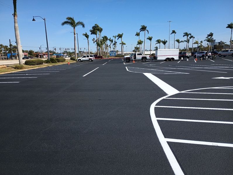 A parking lot with palm trees in the background