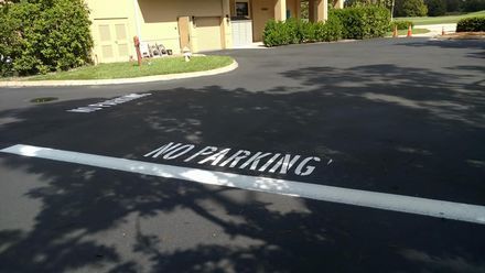 A parking lot with a no parking sign painted on it