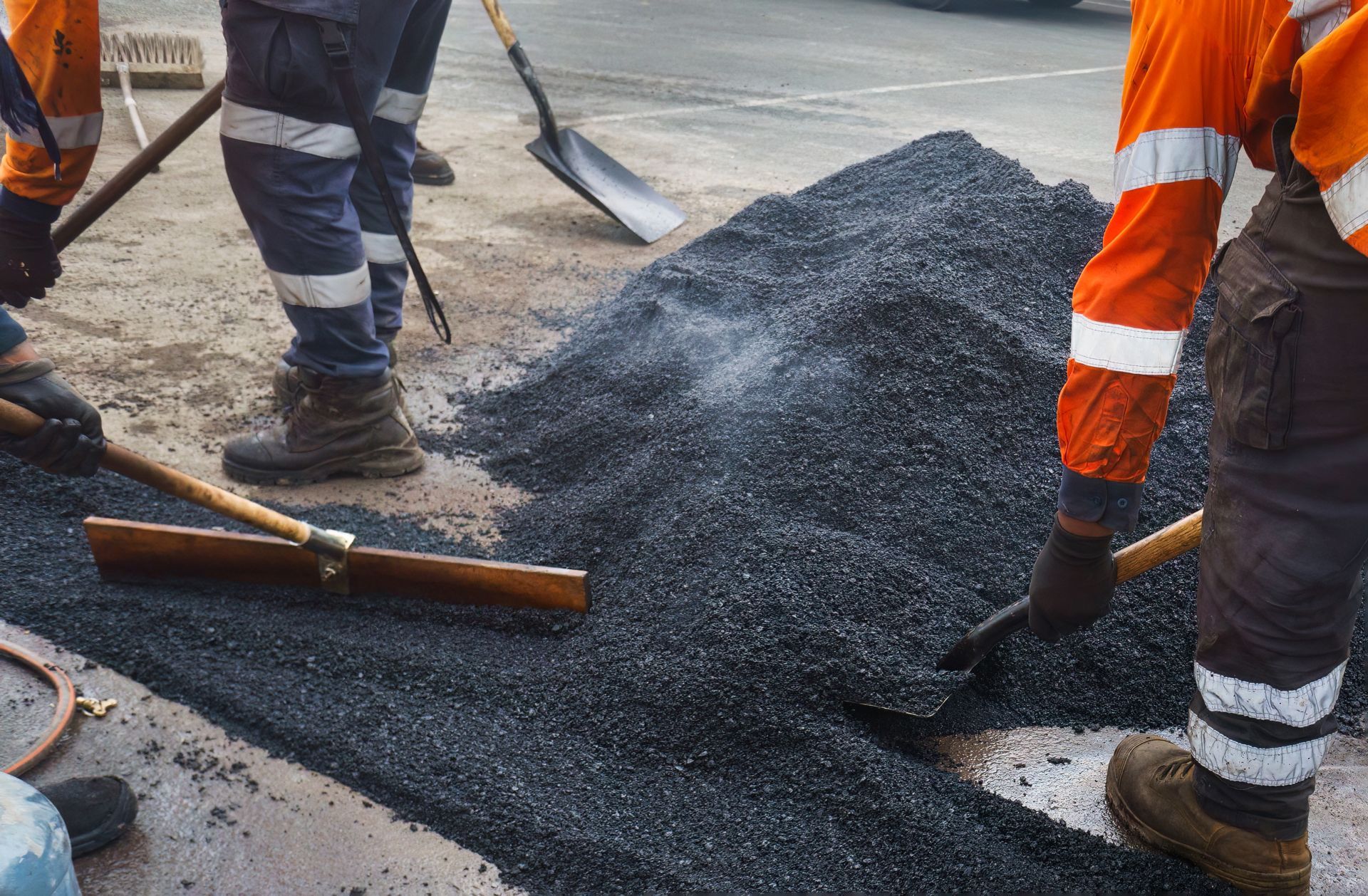 A Group of Construction Workers Are Working on a Road