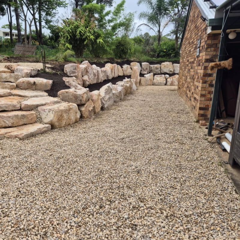 A Gravel Driveway Leading to A Brick Building — CK's Milling & Earthworks in Bells Bridge, QLD
