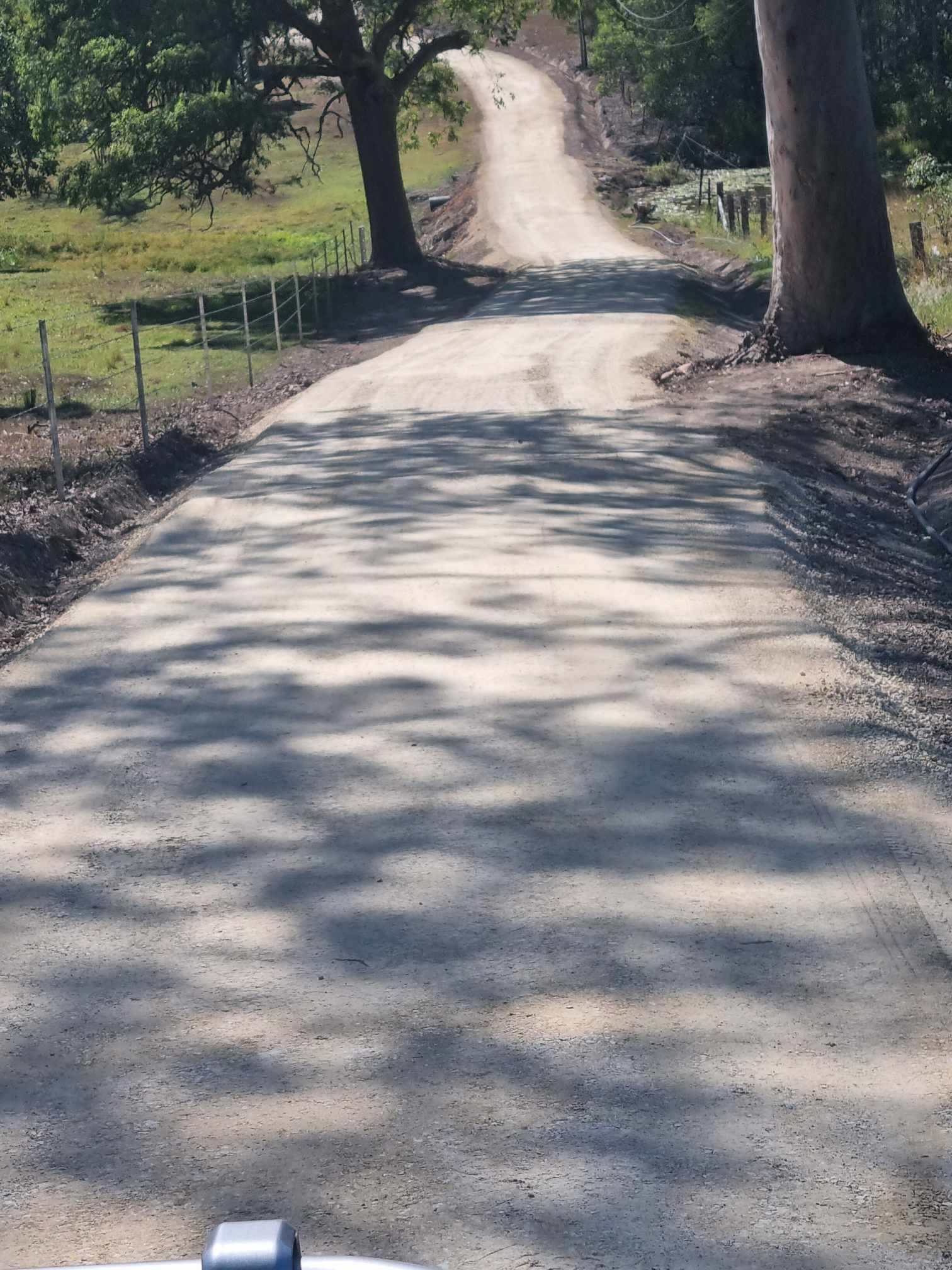 A Gravel Driveway Sits Between Two Pieces of Land — CK's Milling & Earthworks in Bells Bridge, QLD