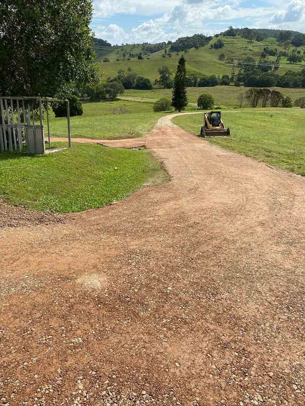 A Dirt Road Going Through a Grassy Field — CK's Milling & Earthworks in Tiaro, QLD