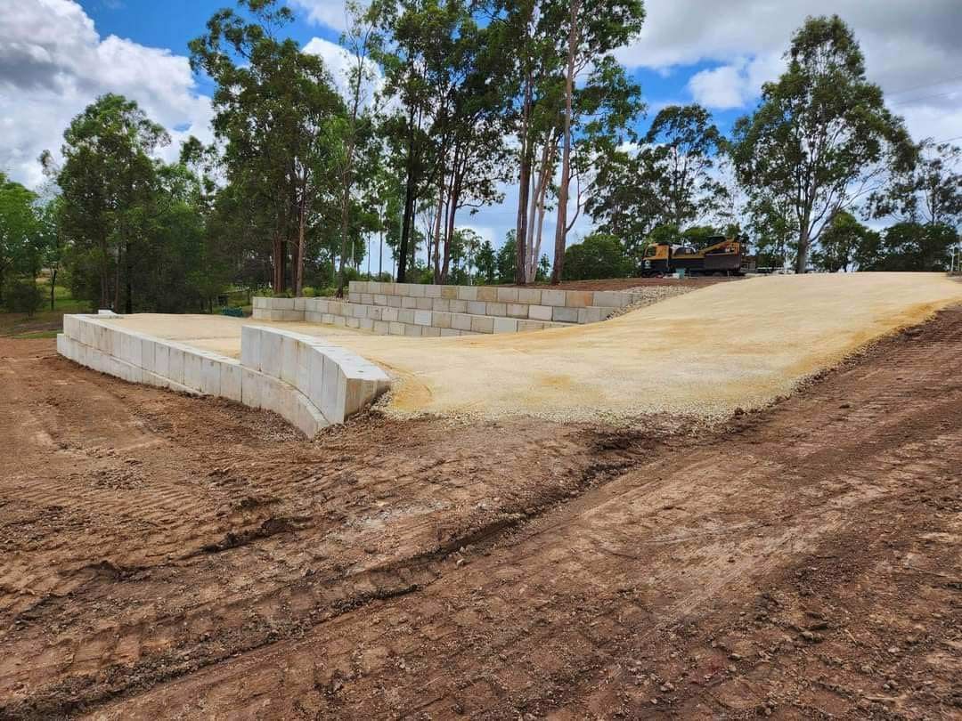 A Dirt Road Going up A Hill with Trees in The Background — CK's Milling & Earthworks in Bauple, QLD
