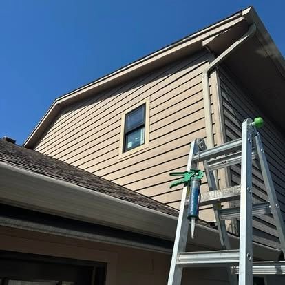 A ladder is leaning against the side of a house.