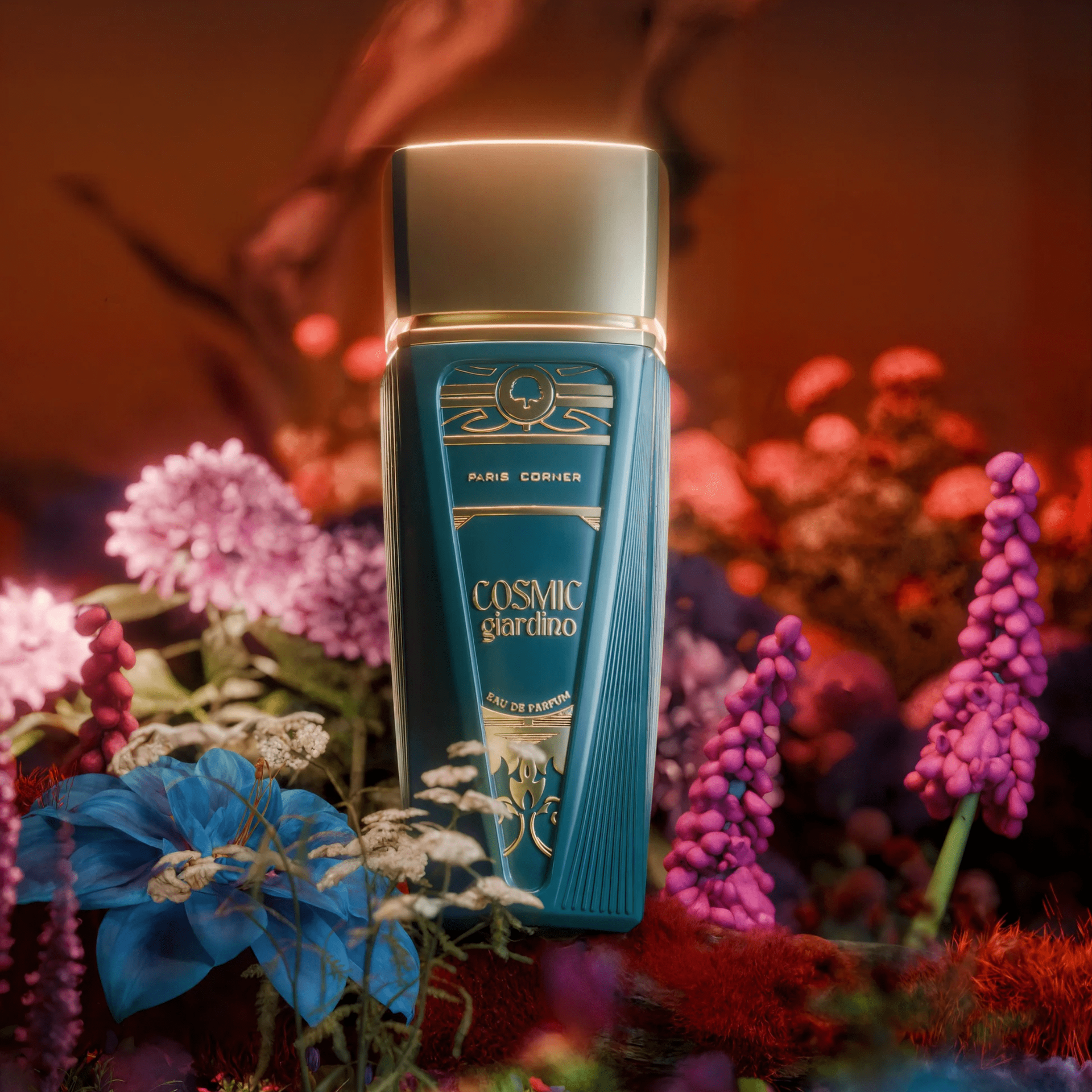 Teal Cosmic Garden perfume bottle with gold accents, surrounded by vibrant flowers, against a reddish backdrop.