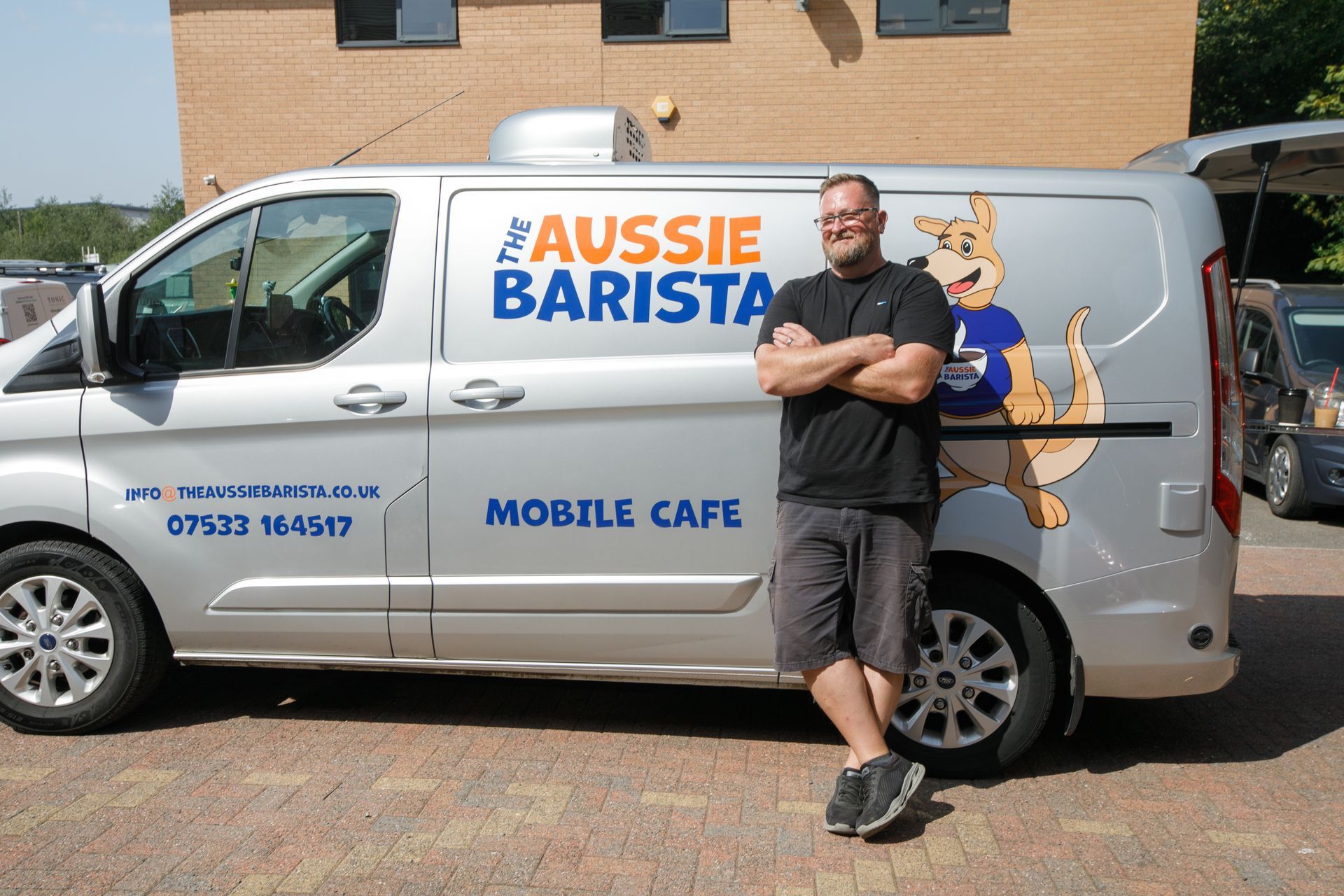 Man leans against silver van with