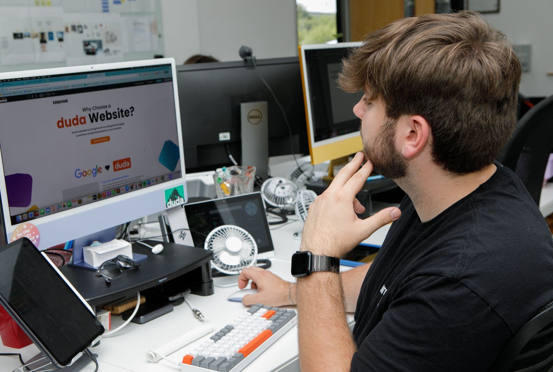 Man at desk with computer, searching