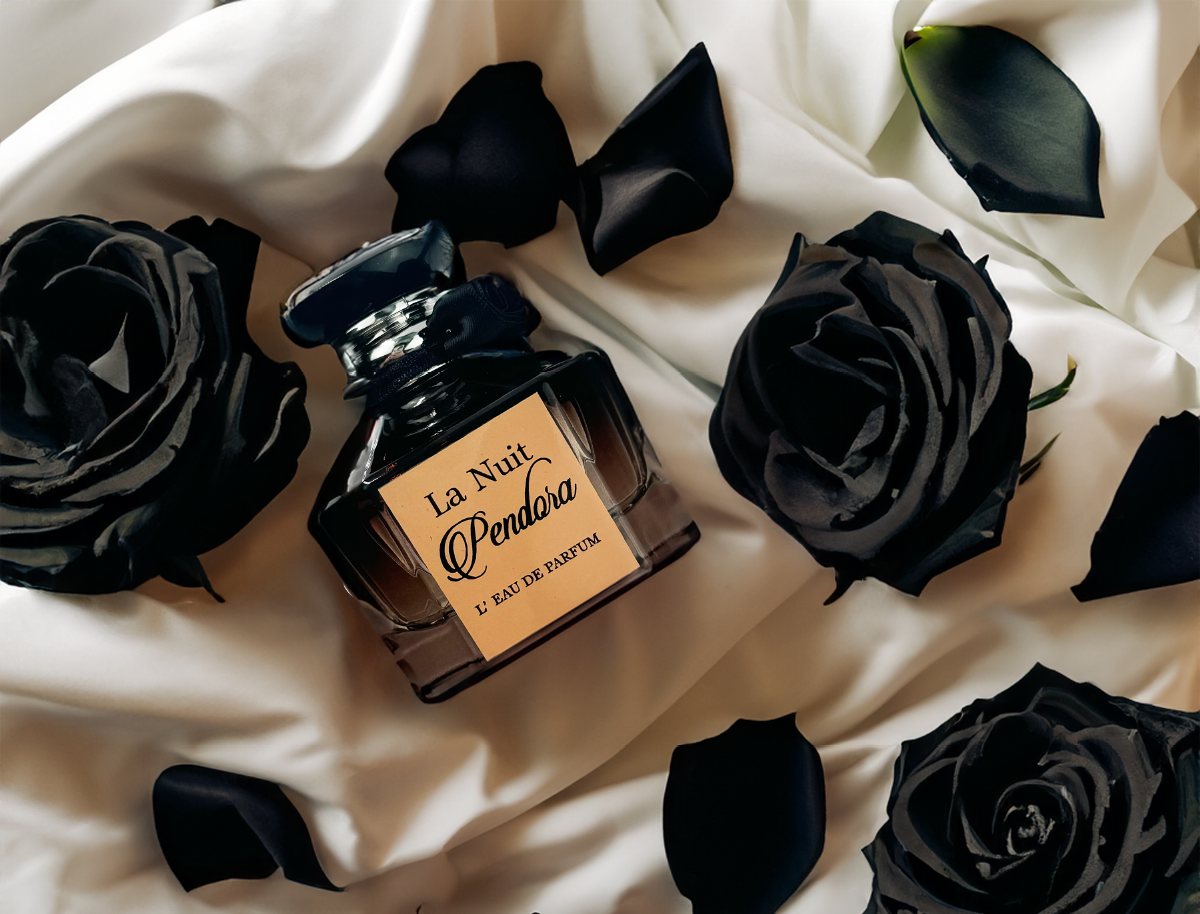 Black roses and petals surround a perfume bottle on a white cloth.