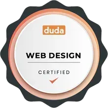 A circular Duda web design certification badge in orange, white, and dark gray with a checkmark.