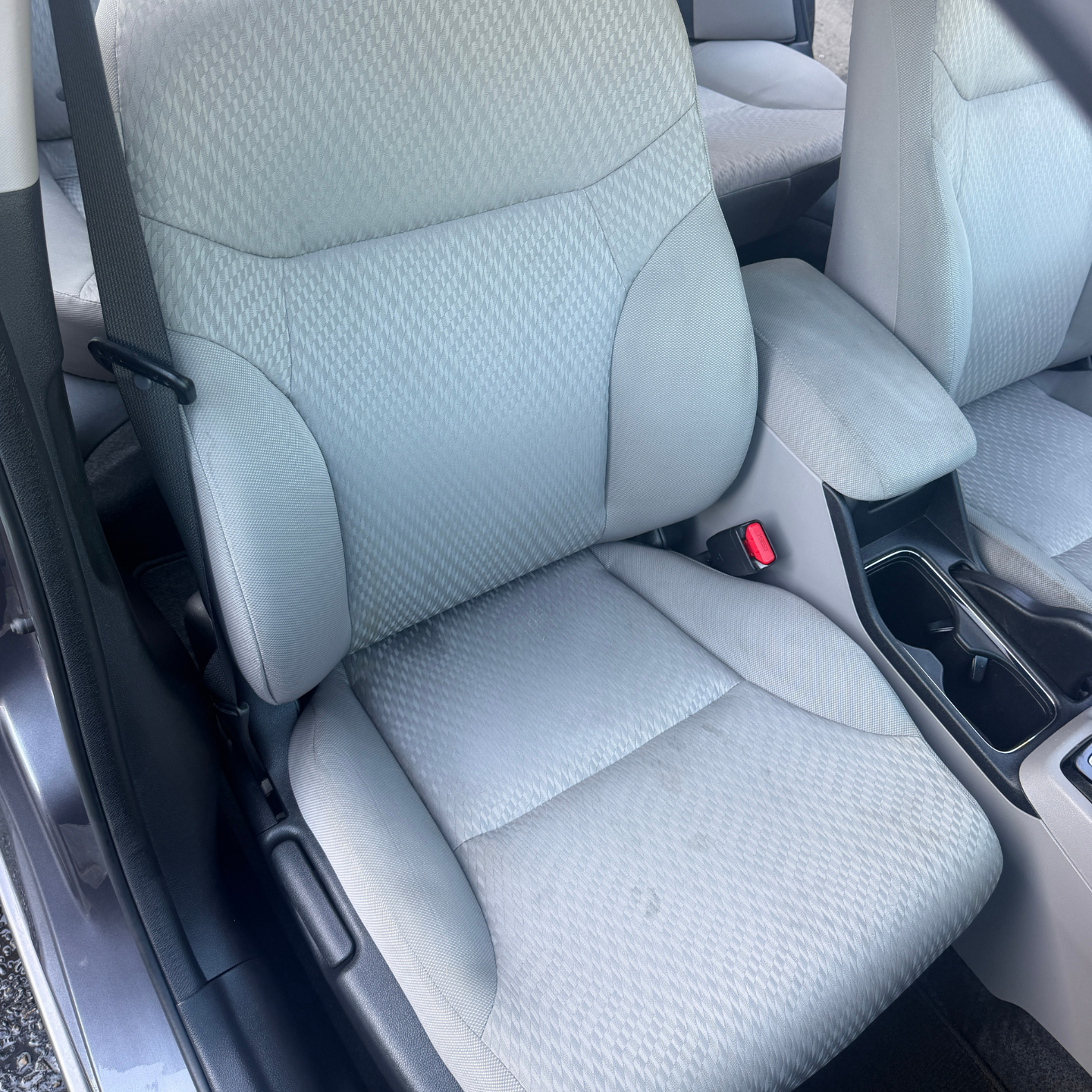 The inside of a car with the door open