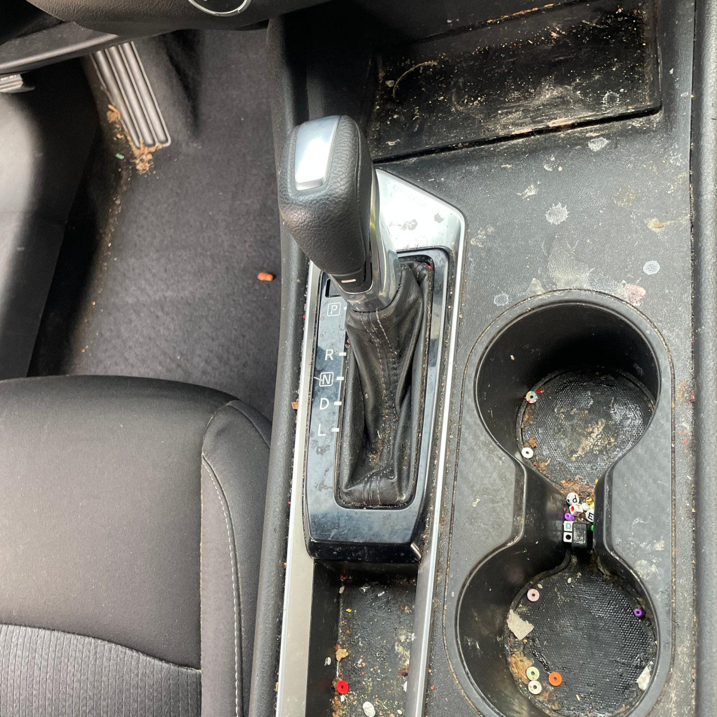 A car with a dirty carpet and a dirty air vent