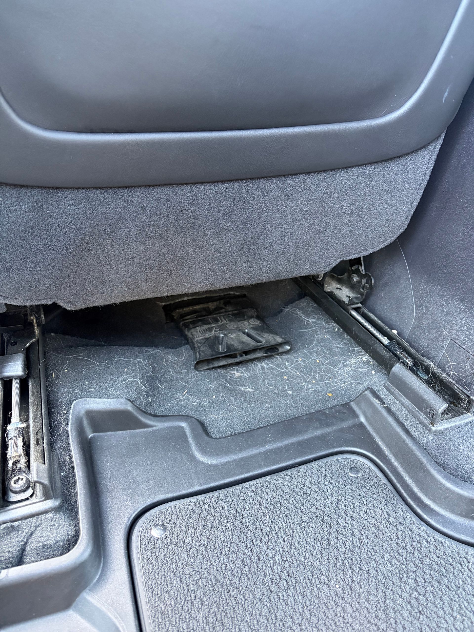 The inside of a car with a steering wheel and seats before cleaning