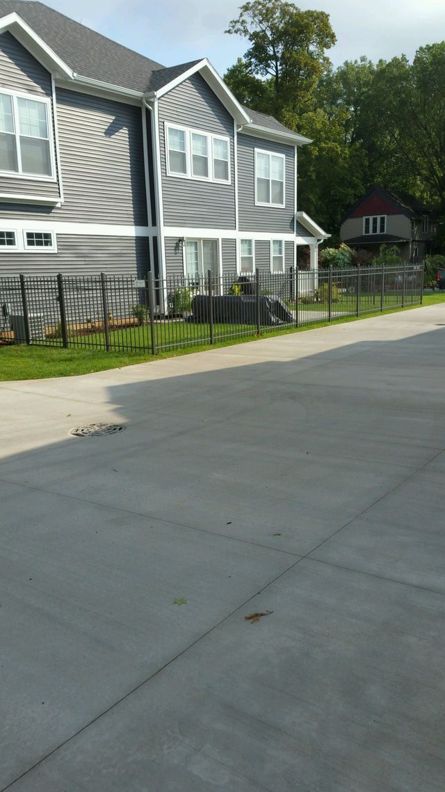A House With A Fence And A Driveway In Front Of It – Mishawaka IN - Milestone Fence