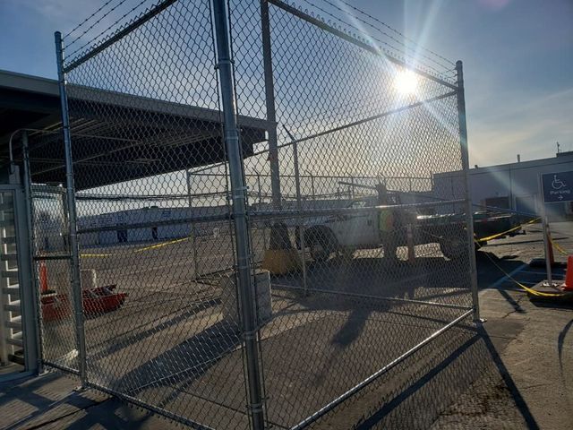 A Chain Link Fence Is Surrounding A Parking Lot – Mishawaka IN - Milestone Fence