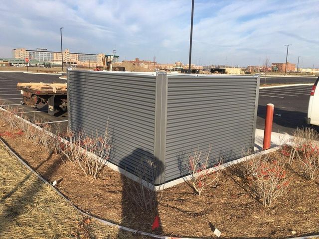 A Gray Fence Is Sitting In The Middle Of A Parking Lot – Mishawaka IN - Milestone Fence