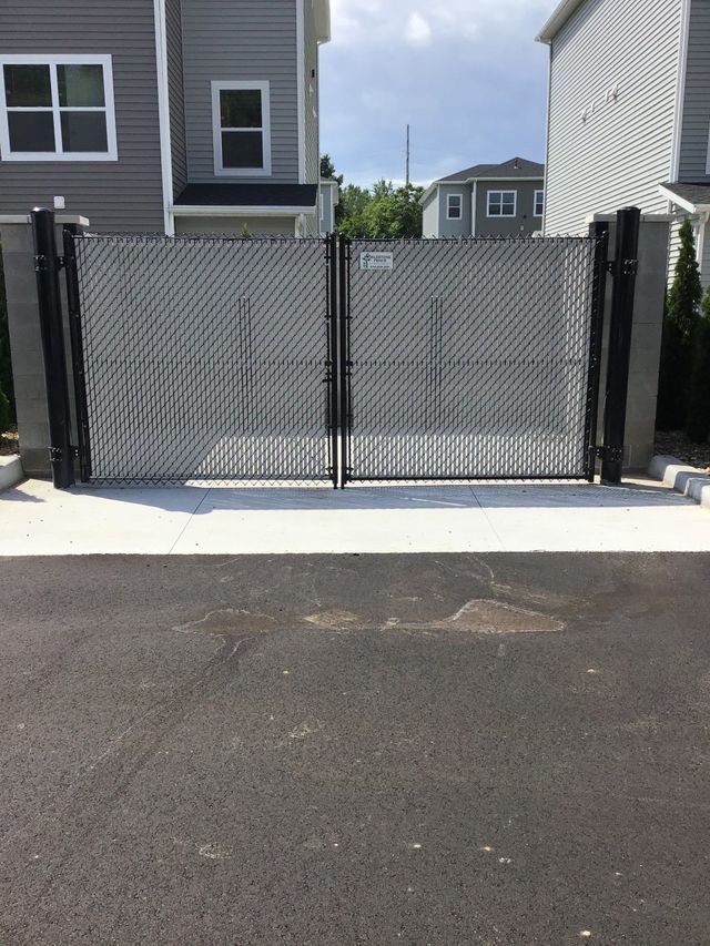 A Chain Link Gate Is Open In Front Of A House – Mishawaka IN - Milestone Fence