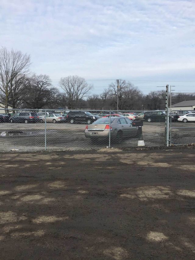 A Car Is Parked In A Parking Lot Behind A Chain Link Fence – Mishawaka IN - Milestone Fence