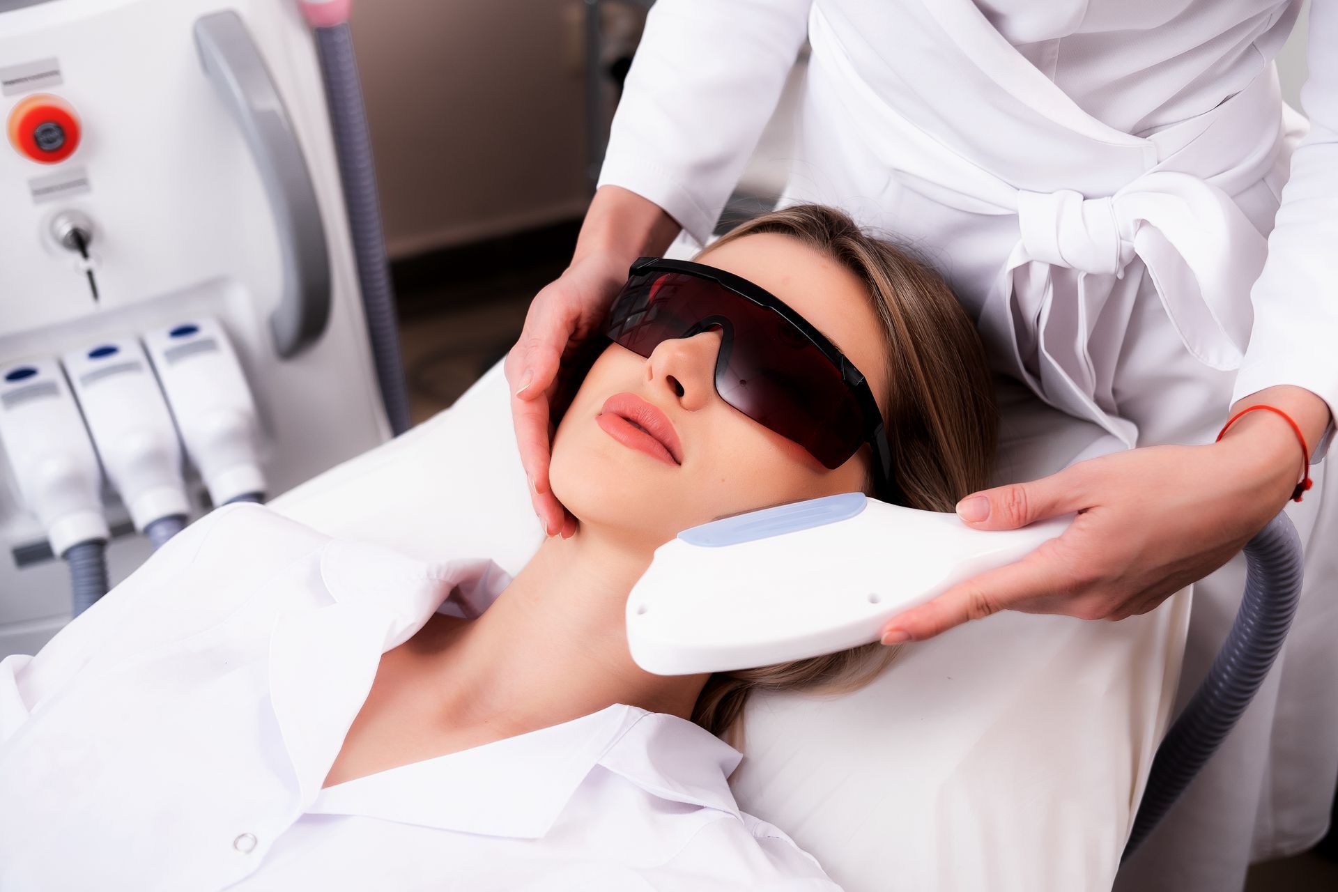 Person receiving a facial treatment while wearing protective goggles in a spa/clinic setting