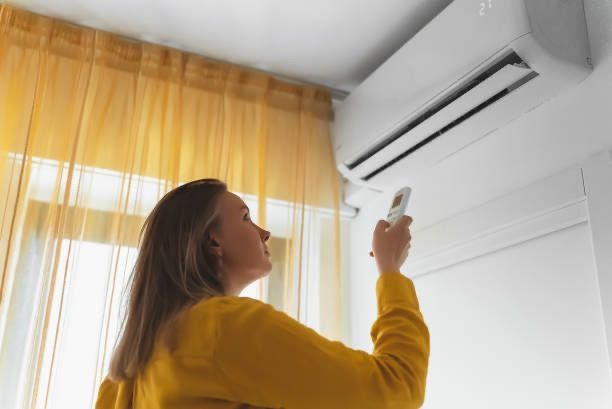 woman checking her air conditioning system