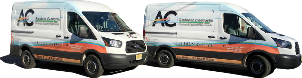Two white vans with AC logos parked outdoors.
