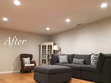 A living room with a couch , chair and ottoman.
