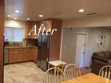 A kitchen with wooden cabinets and stainless steel appliances and a dining table and chairs.