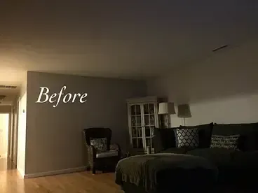 A living room with a couch , chair , lamp and a sign that says `` before '' on the wall.