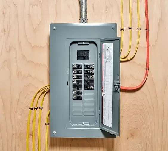 A close up of an electrical panel on a wooden wall.