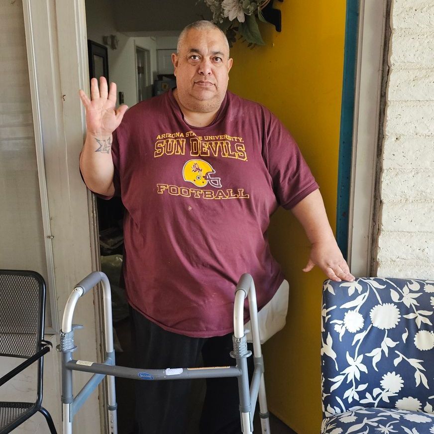 A man wearing a shirt that says sun devils on it