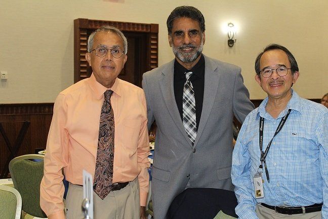 three men are posing for a picture in a room