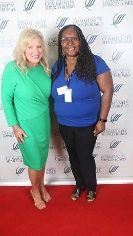 Nikki, 10-years of service recognized employee (R) with the Director of Youth and Family Services