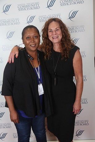 Marcena, 10-years of service recognized employee (L) with the Director of Developmental Services