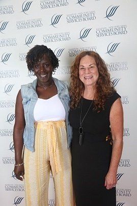 Melissa, 10-years of service recognized employee (L) with the Director of Developmental Services