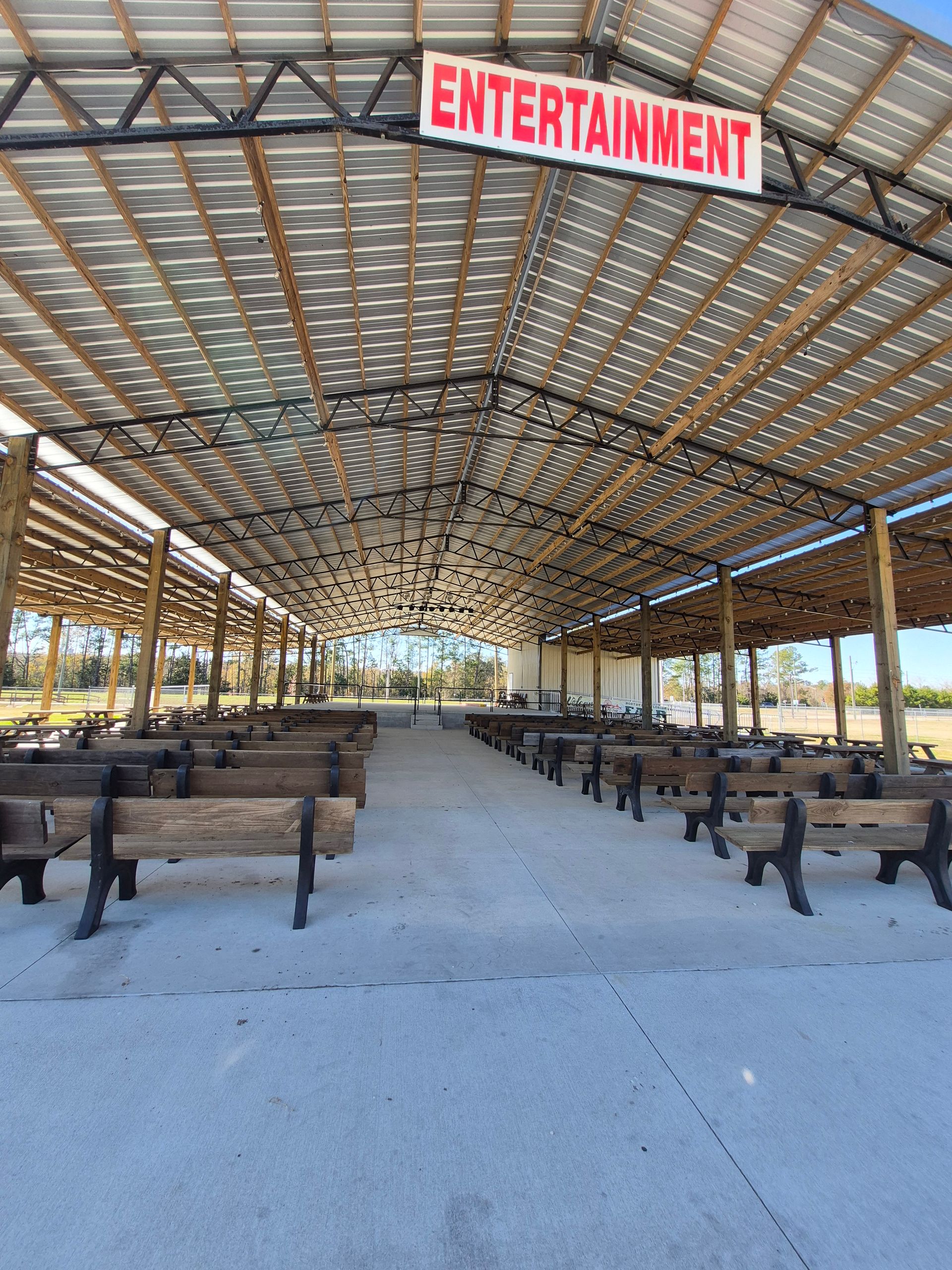 Community fair tables with colorful tablecloths and display signs in a gymnasium￼