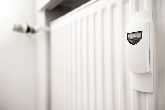 White radiator with digital thermostat showing 19.2°C.