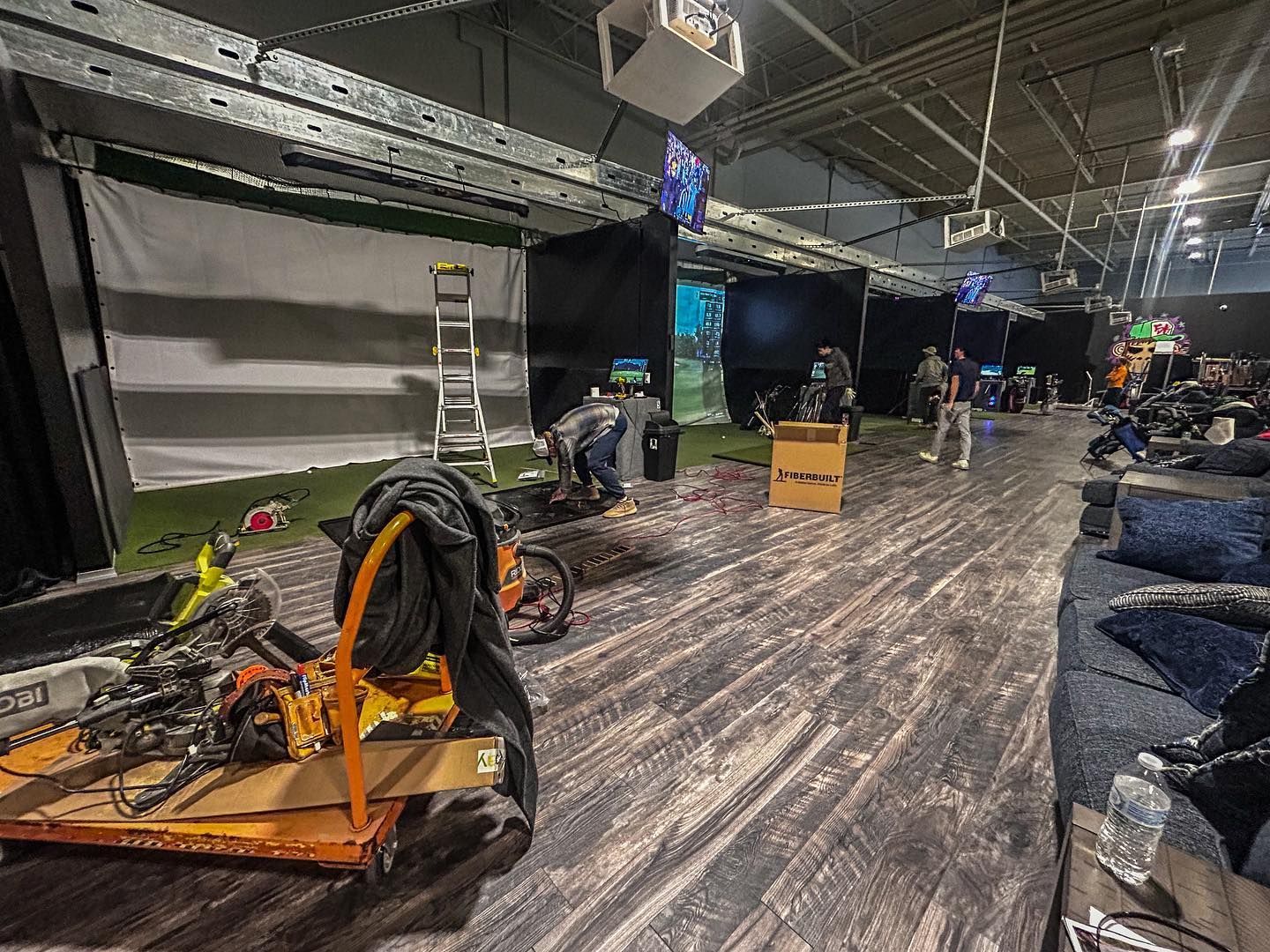 A large room with a lot of furniture and tools on the floor.