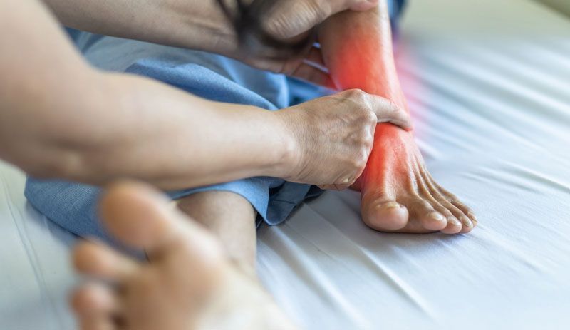 A doctor inspecting a patient ankle