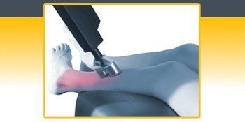 A person 's ankle is being treated with a machine