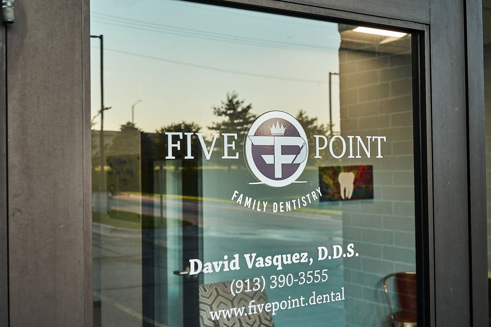 Glass door of Five Point Family Dentistry with logo and contact information.