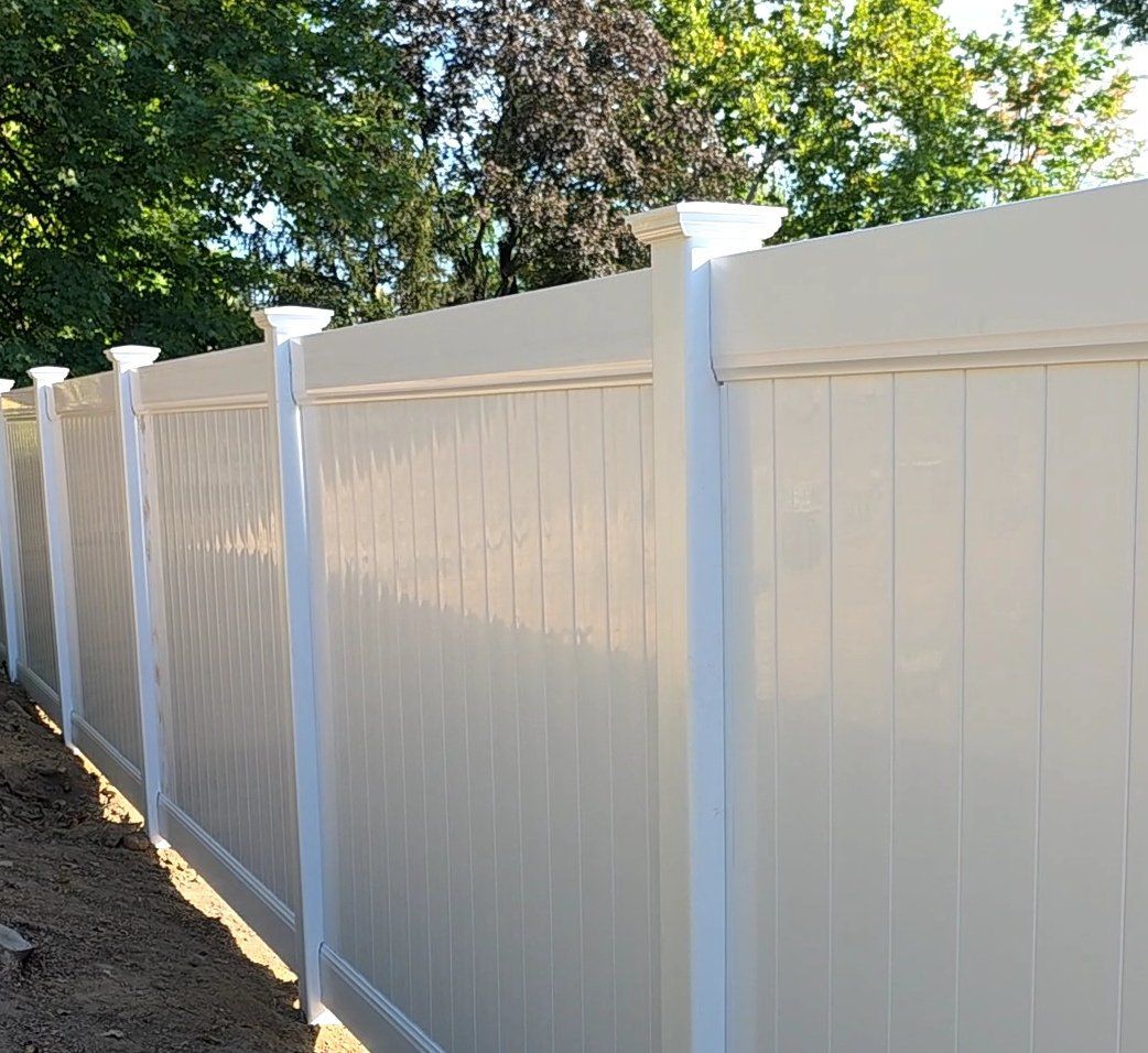 Installed white vinyl fence — Solanos Fence