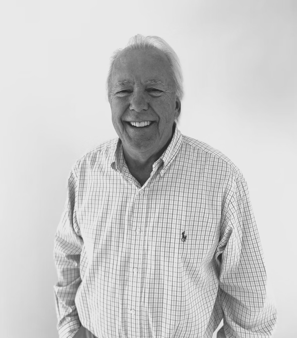 Dr. Leif E. Leaf. man in a plaid shirt is smiling in a black and white photo.