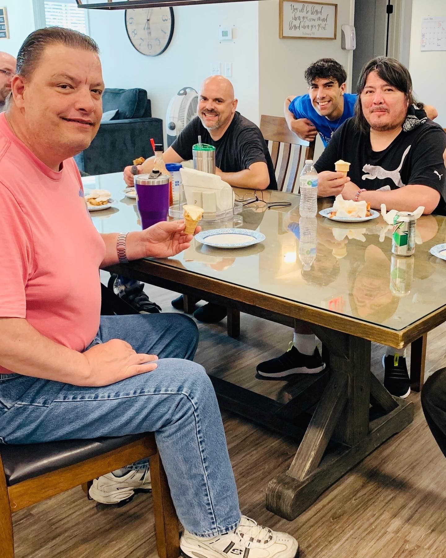 A group of people are sitting at a table eating food.