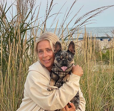 Adrienne Agresti hugging French bulldog at the beach