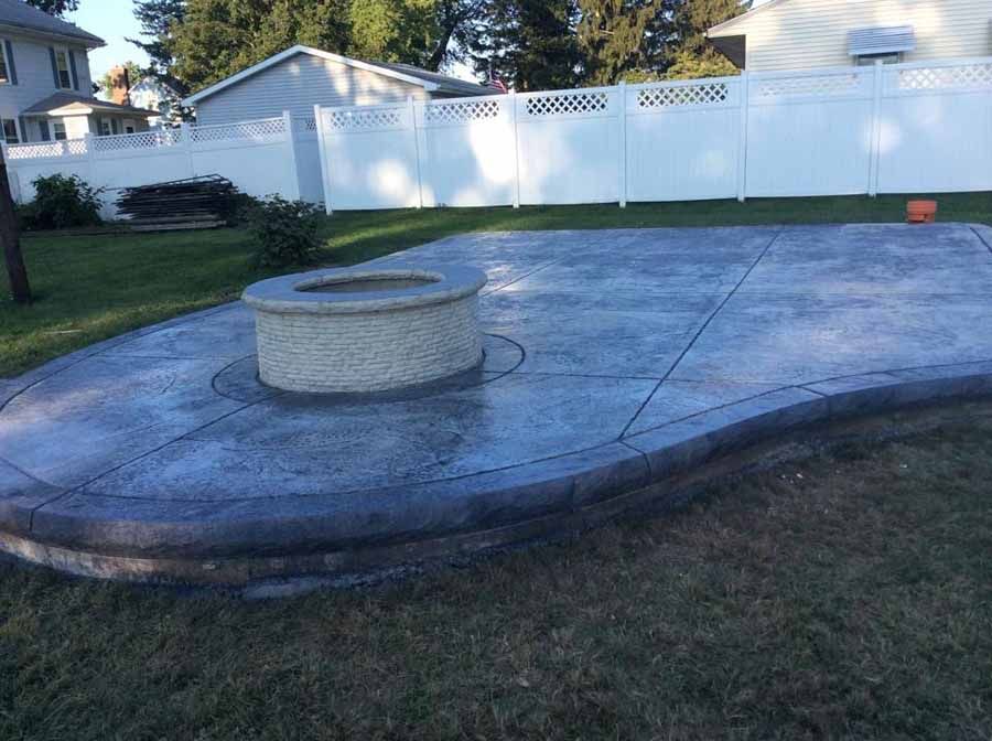 There is a fire pit in the middle of the patio.