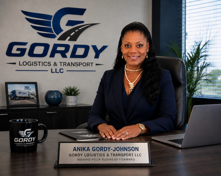 Anika, founder of Gordy Logistics, standing outside her delivery vehicle