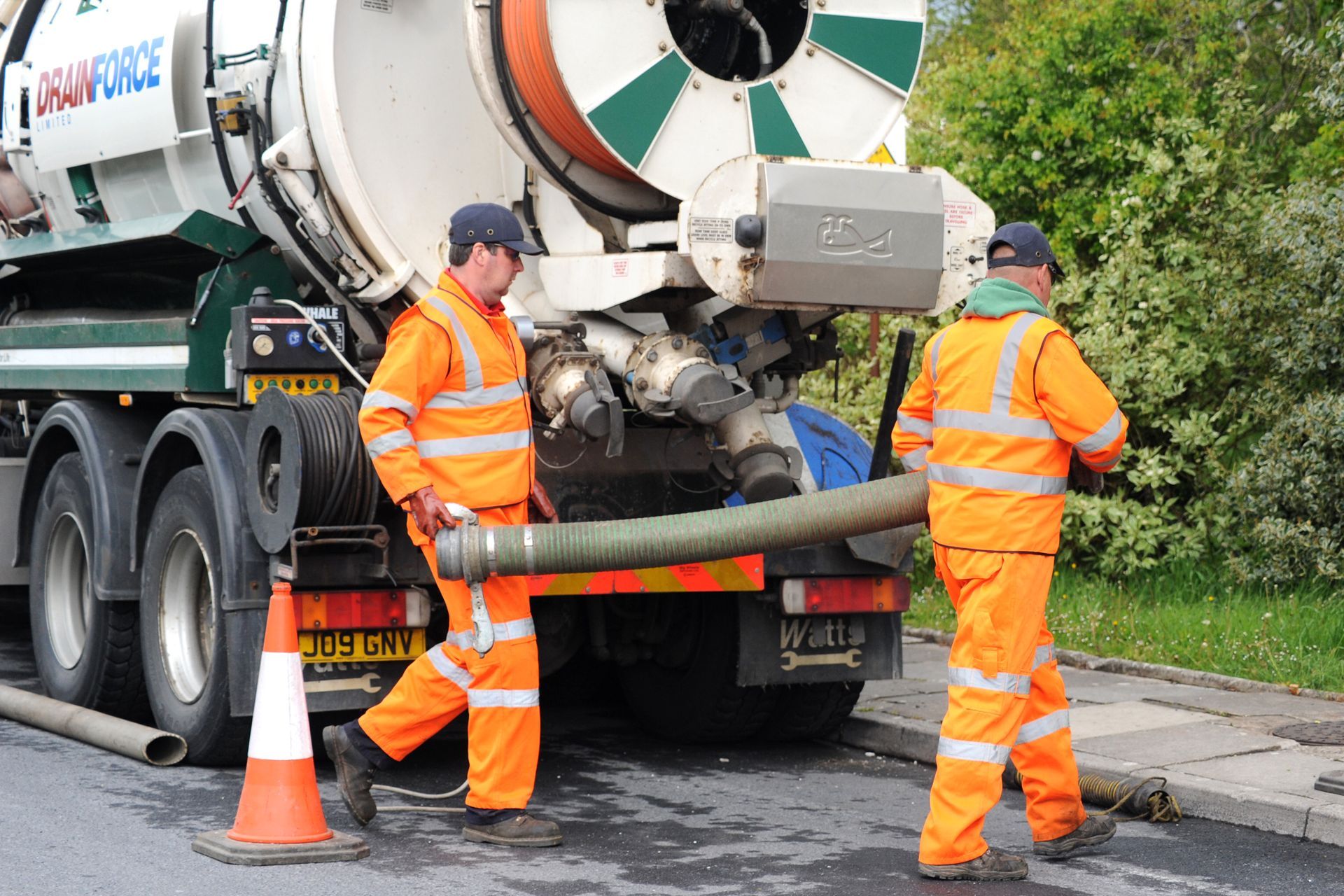 Drainforce staff unloading suction tube from 4,000 gallon cesspit tanker.