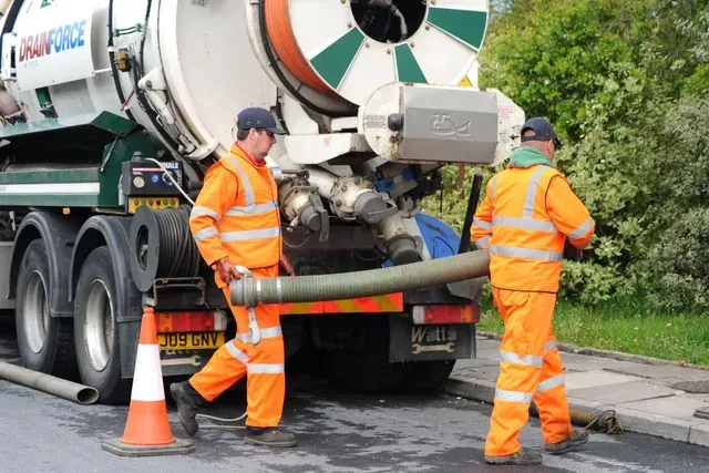 Drainforce staff unloading suction tube from 4,000 gallon cesspit tanker.