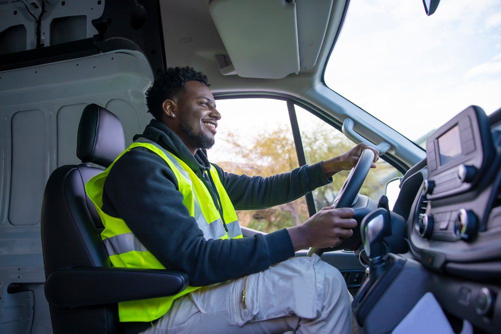 Smiling Man Driving Cargo Van — Scottsdale, AZ — J.B. Martin Insurance Agencies Smiling Man Driving Cargo Van — Scottsdale, AZ — J.B. Martin Insurance Agencies