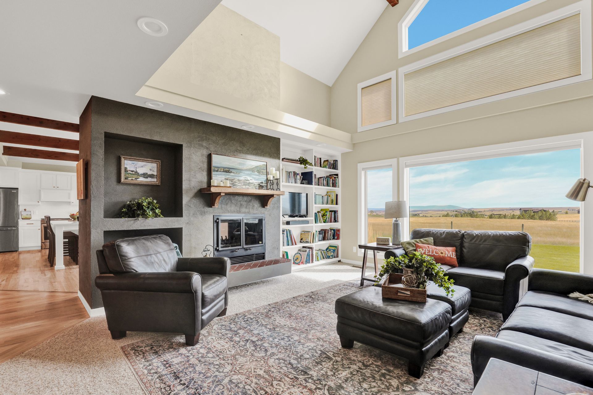 Open concept kitchen with dark island and stainless appliances in Great Falls MT home