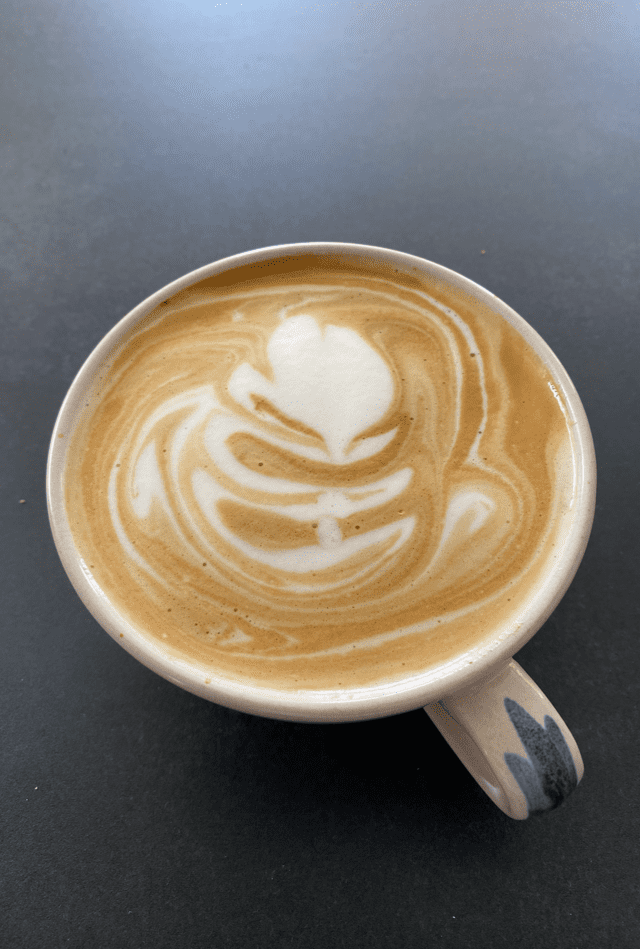 A close up of a cup of cappuccino on a table